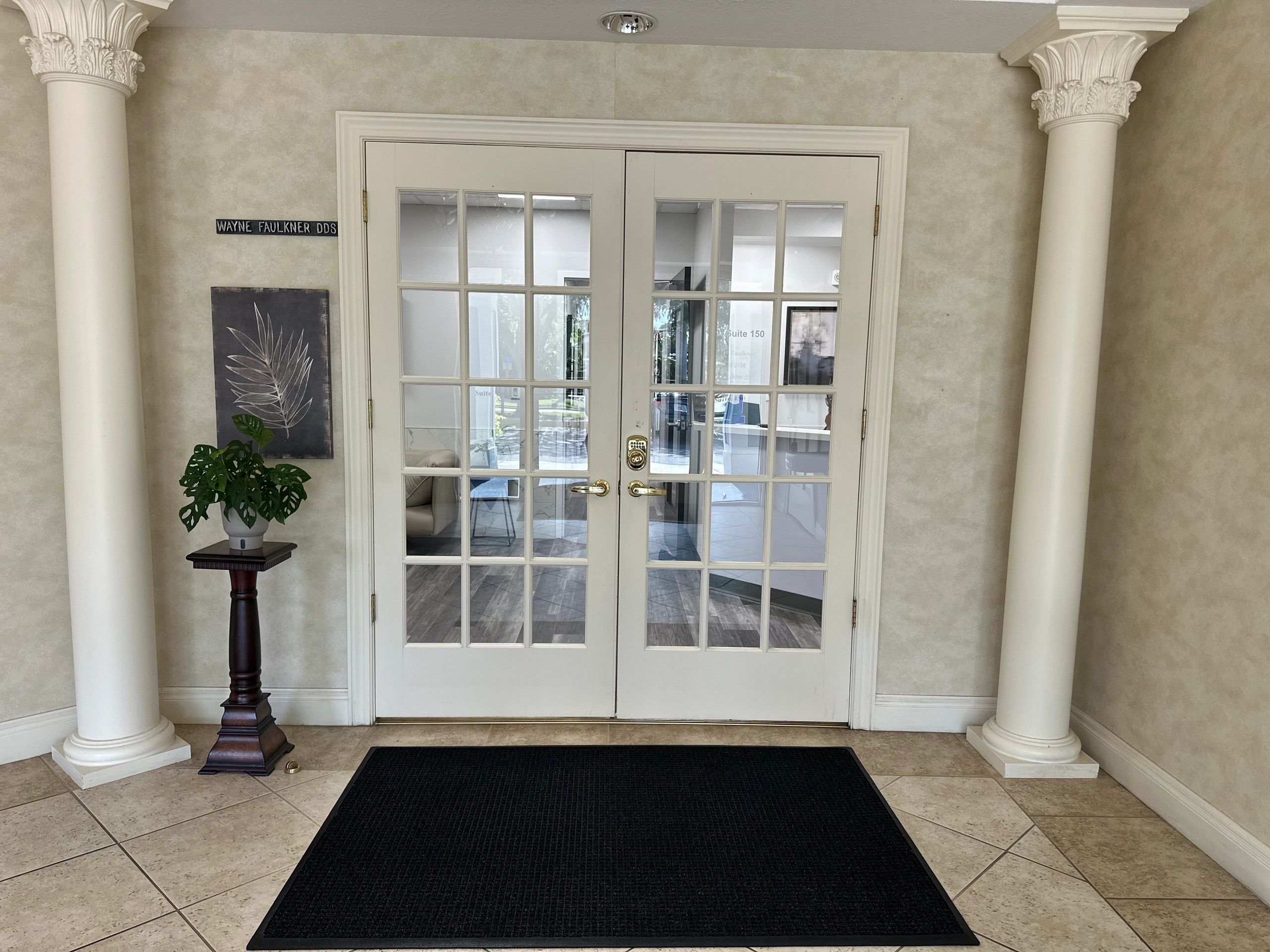 Entrance to Wayne Faulkner DDS, Suite 150, with white French double doors